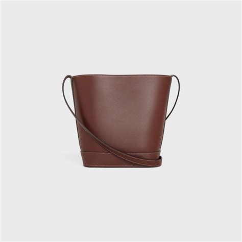 SMALL BUCKET CUIR TRIOMPHE IN SMOOTH CALFSKIN.